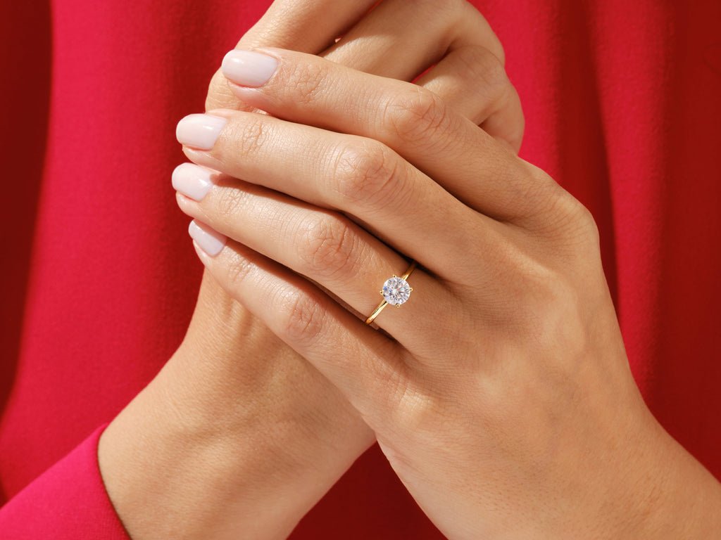 Round solitaire diamond ring presented in signature gift packaging