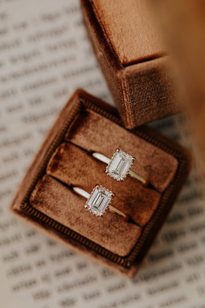 Unboxing view of emerald cut solitaire diamond engagement ring