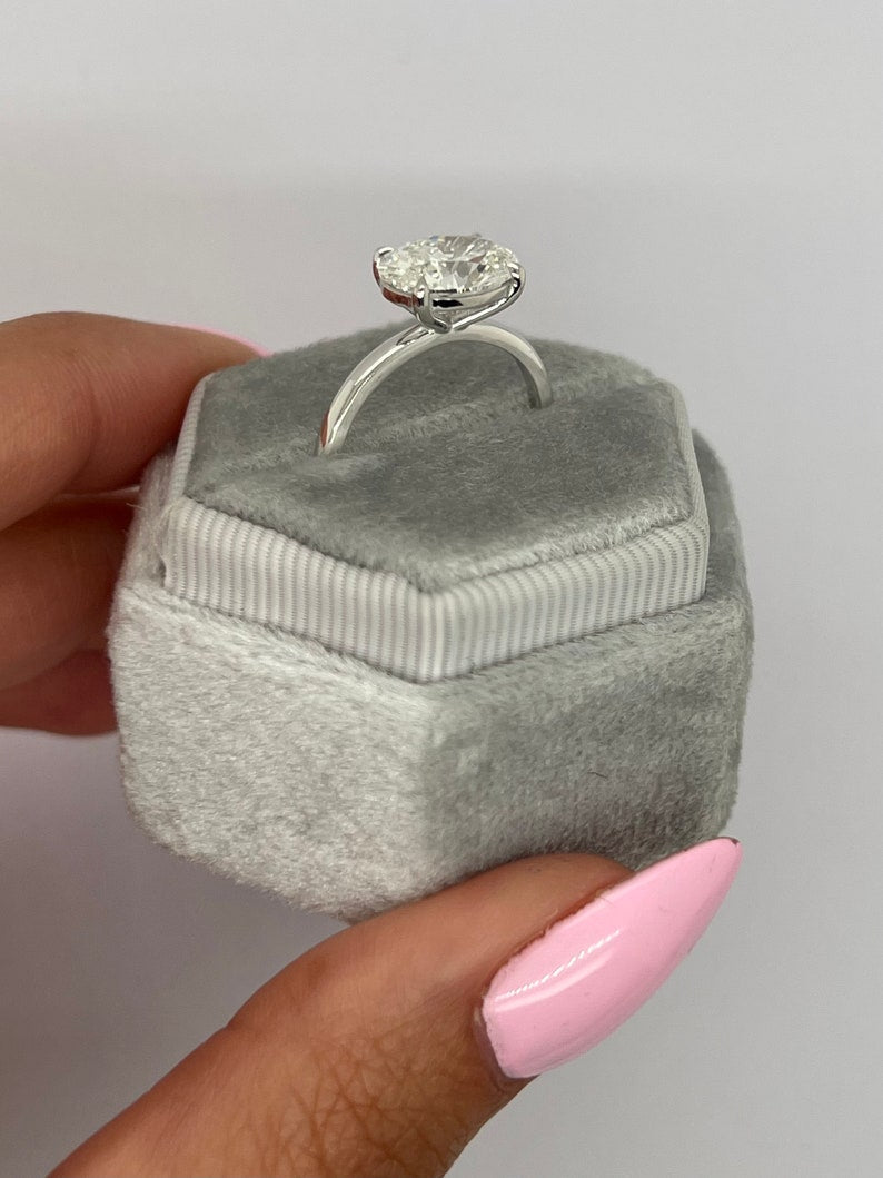Oval solitaire engagement ring viewed from the side