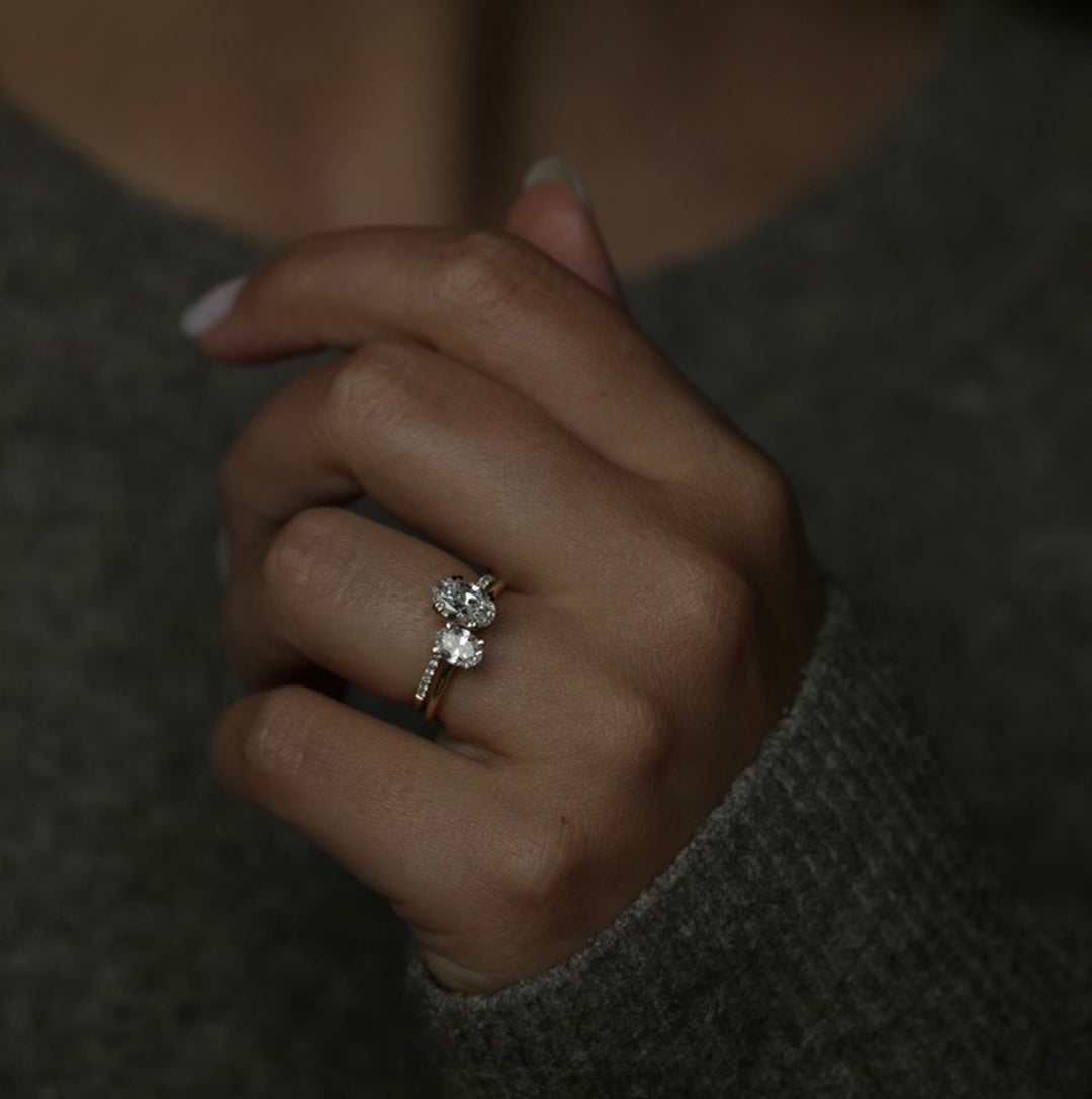 Oval solitaire engagement ring close-up showing E/VVS1 diamond clarity