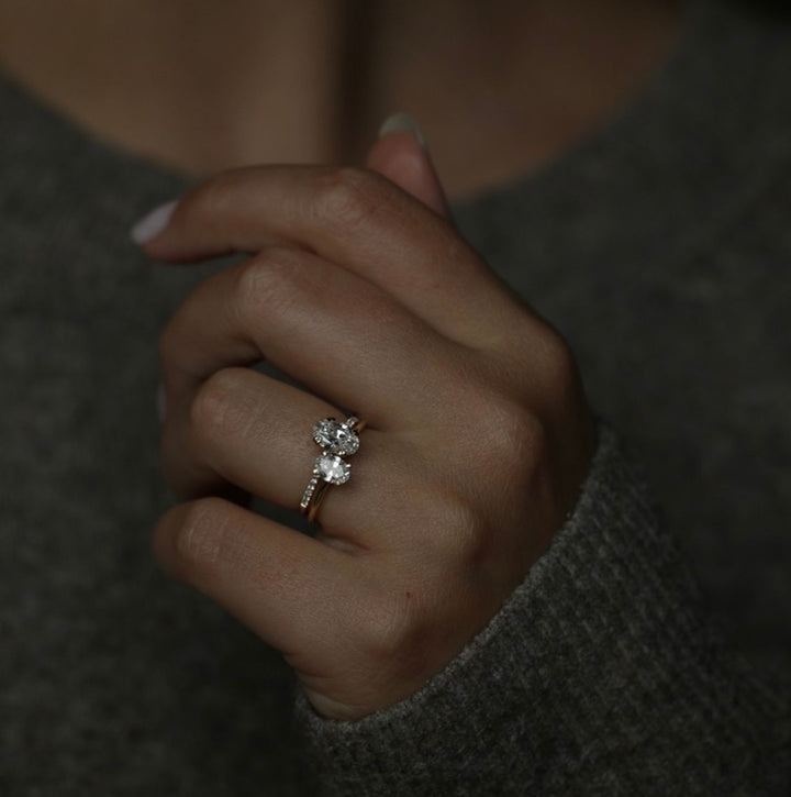 Oval solitaire engagement ring close-up showing E/VVS1 diamond clarity