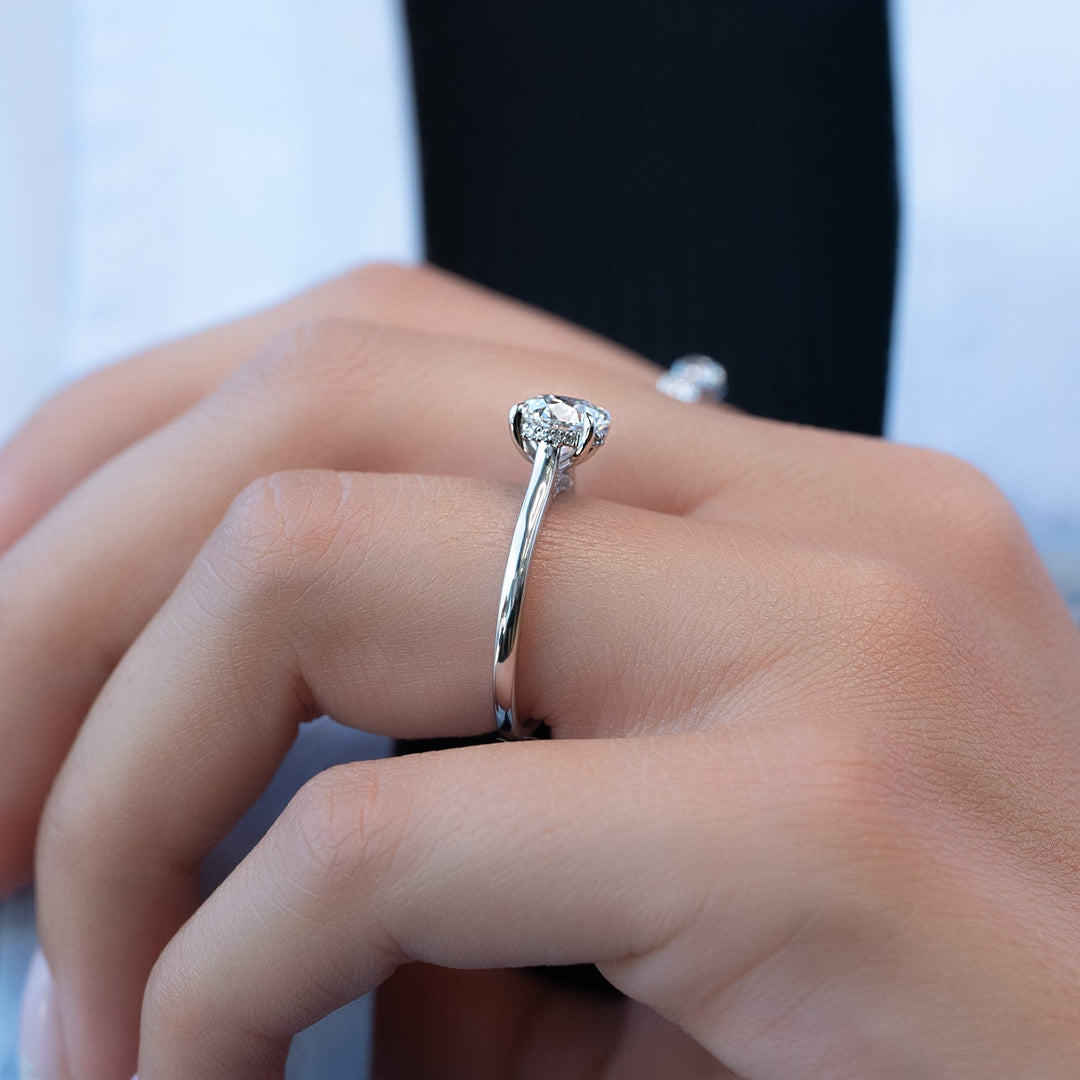 Certified round cut diamond featured in hidden halo engagement ring