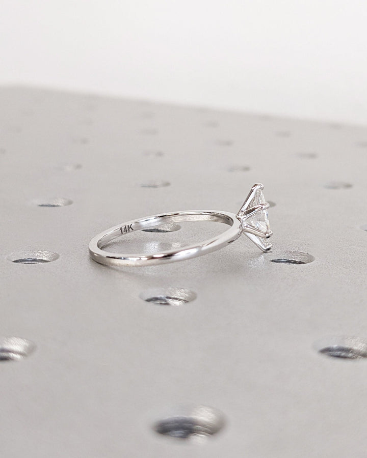 Marquise solitaire engagement ring shown on hand for true-to-life sizing