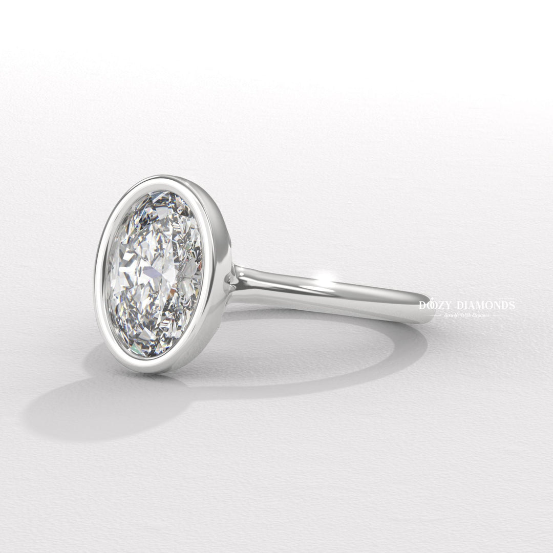 Oval bezel engagement ring finished in polished solid gold