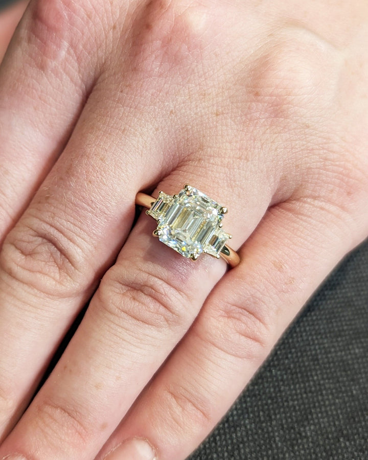 Handcrafted emerald cut three stone lab grown diamond engagement ring