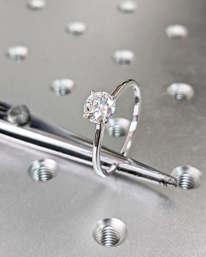 Round solitaire engagement ring with IGI certificate and packaging