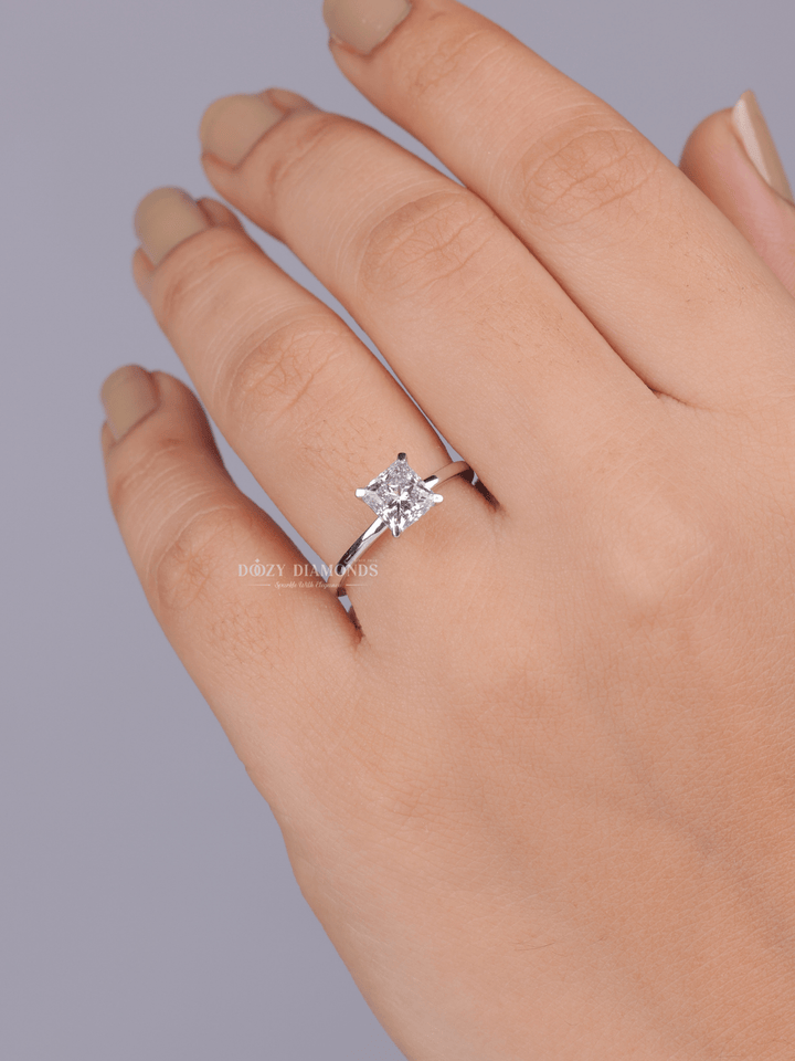 Close-up of princess cut center diamond in solitaire engagement ring