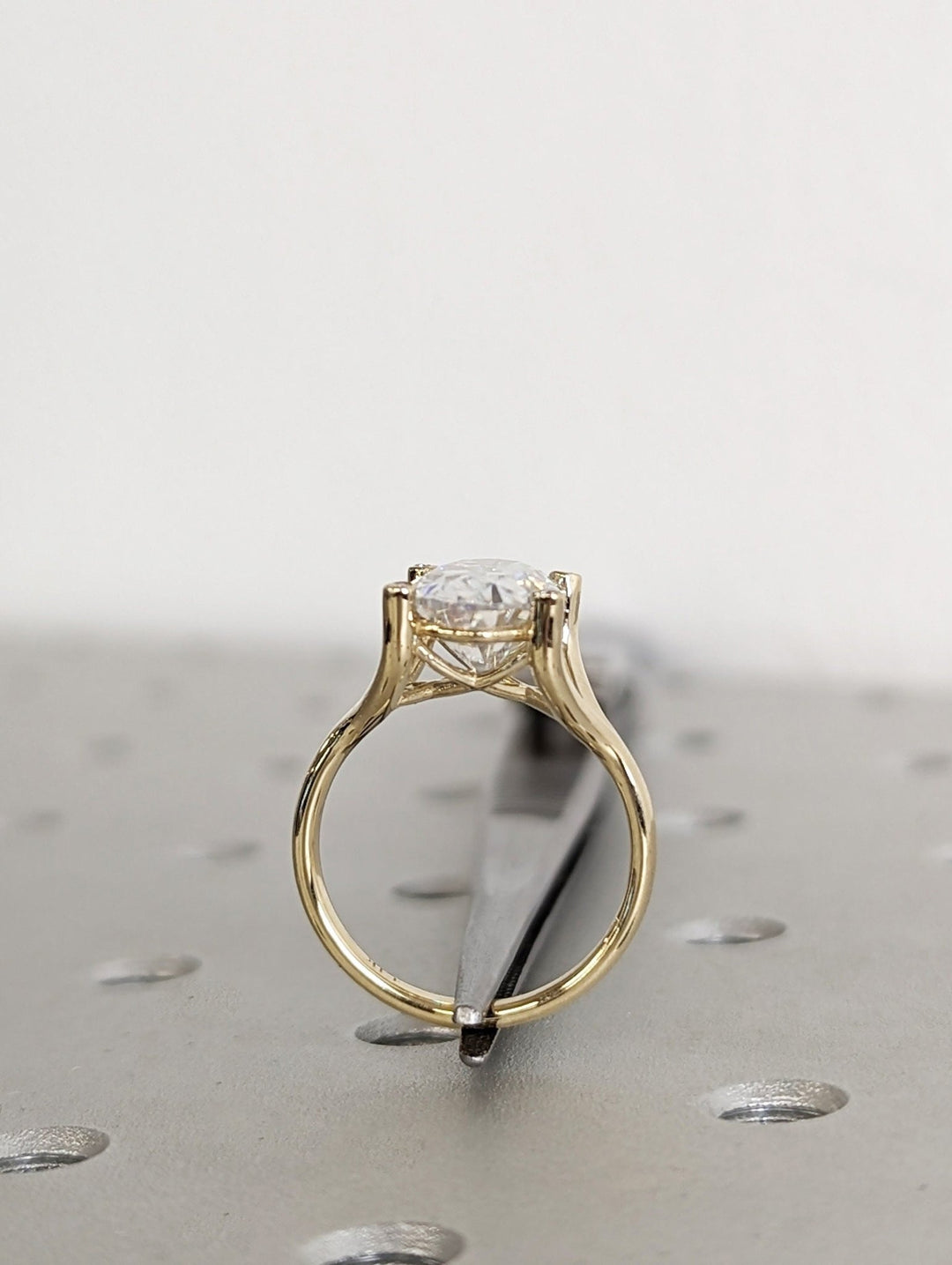 Fine craftsmanship detail on oval solitaire engagement ring