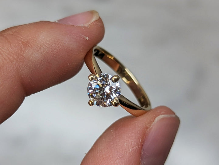 Round cut engagement ring side view showing band detail