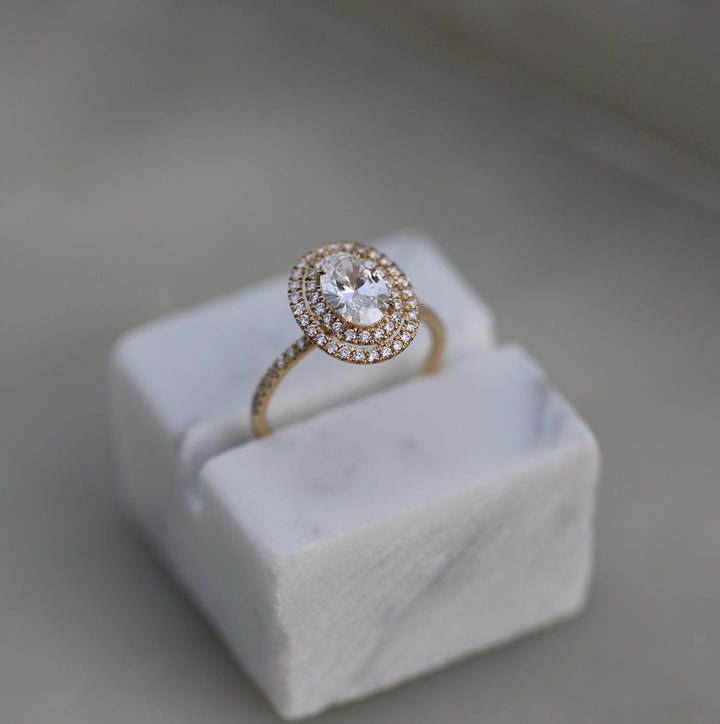 Oval cut diamond ring worn on hand