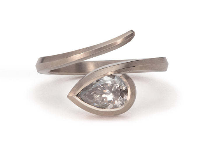 Pear cut solitaire engagement ring shown in real-life wear