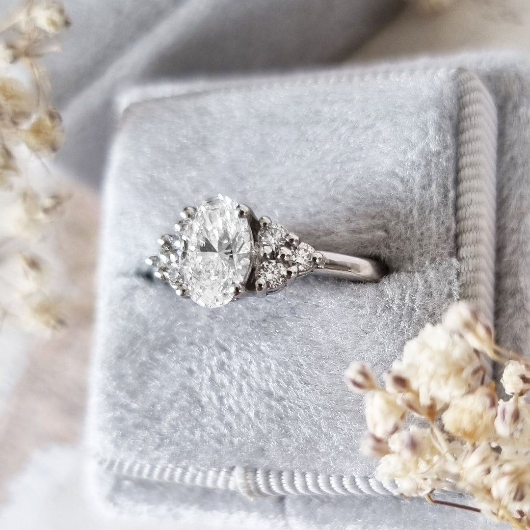 Side angle of oval cluster diamond engagement ring