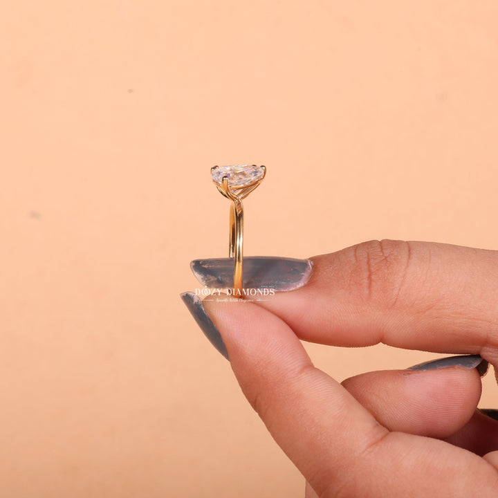 Angled view of oval cut diamond in solitaire setting