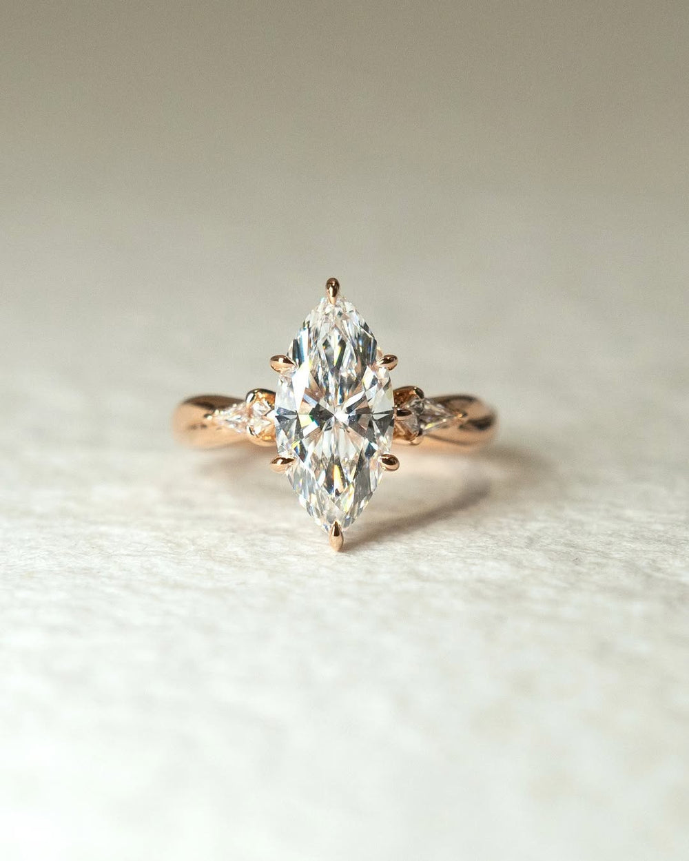 Profile view of marquise cut three stone engagement ring band