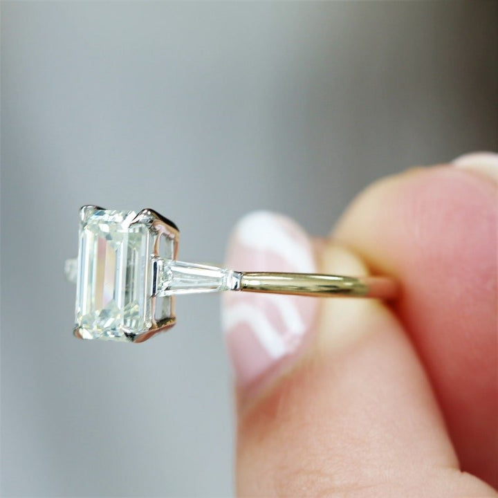 IGI certified emerald cut diamond in three stone engagement ring setting