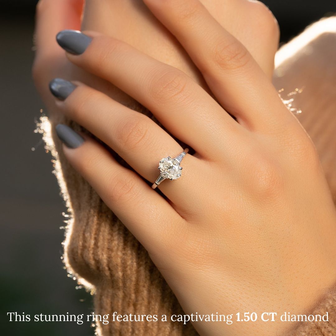 Oval three stone diamond ring displayed on jewelry stand