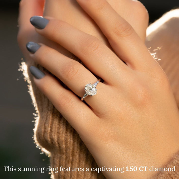 Oval three stone diamond ring displayed on jewelry stand