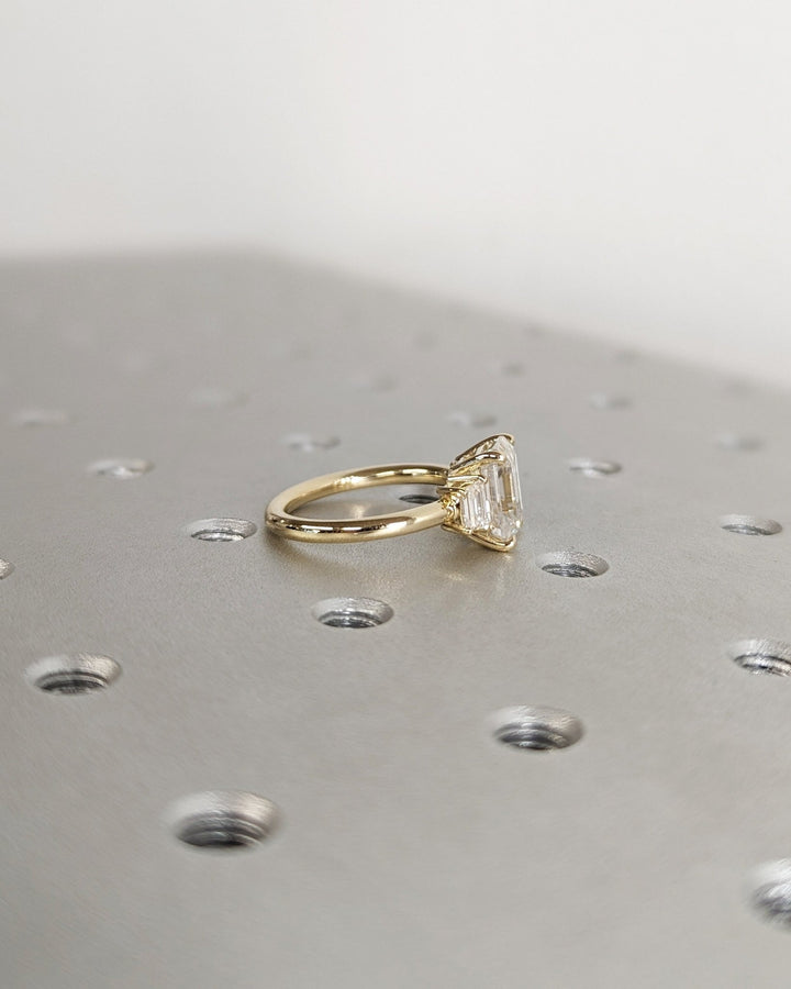 Classic emerald three stone engagement ring crafted for everyday wear