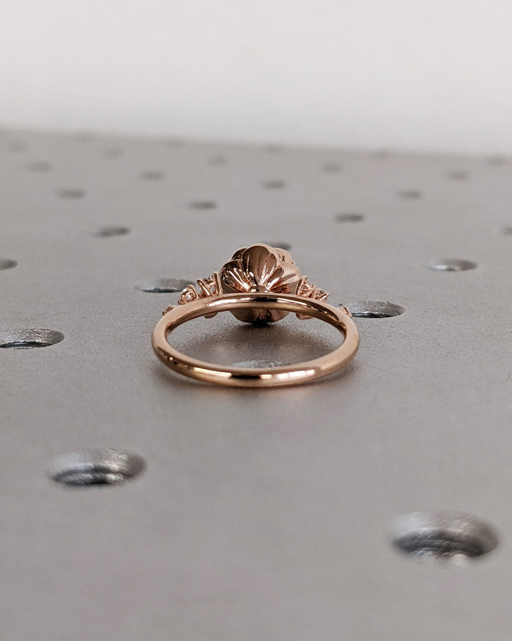 Close-up of round cut center diamond in cluster engagement ring