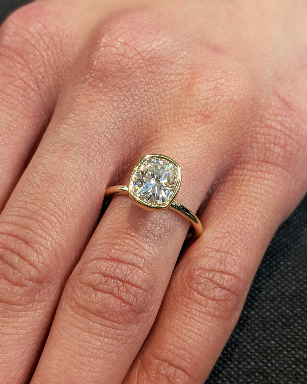 Cushion bezel lab grown diamond ring side profile in gold setting