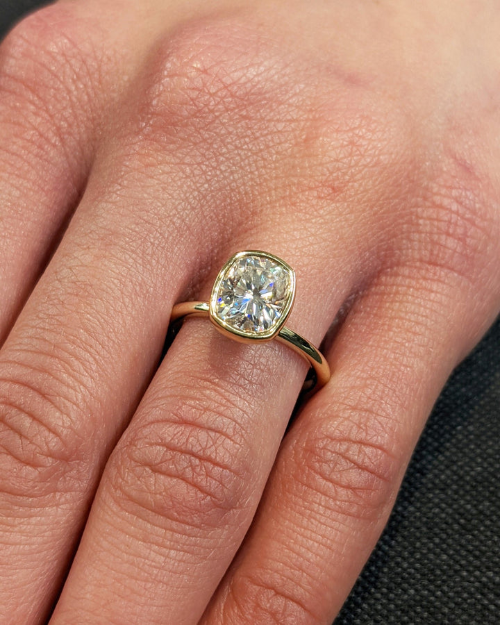 Cushion bezel lab grown diamond ring side profile in gold setting