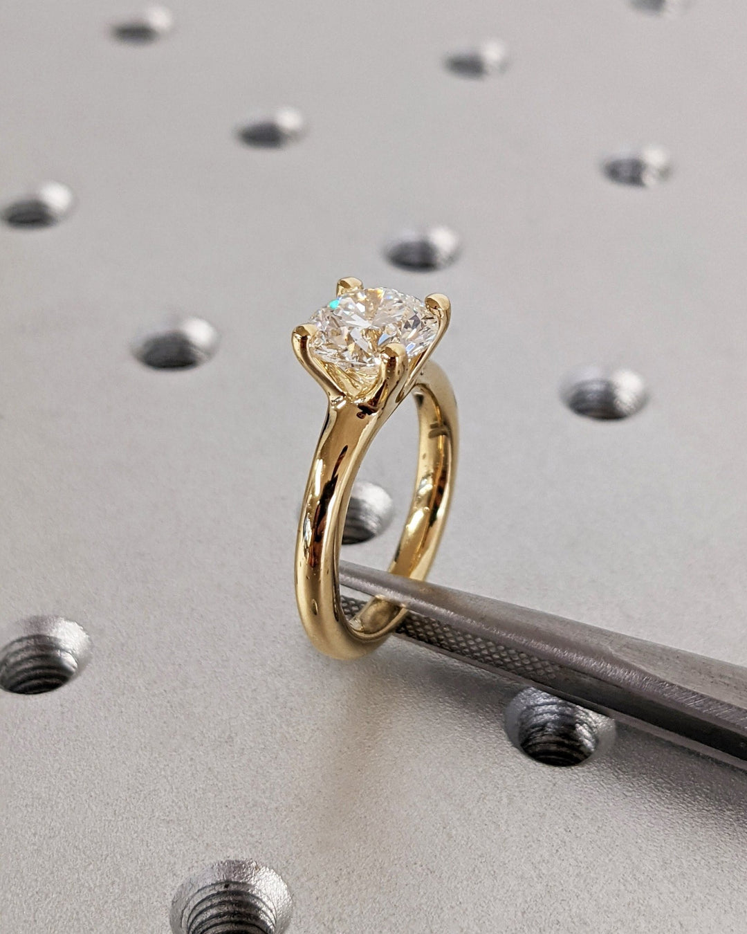 Round solitaire engagement ring viewed from the side
