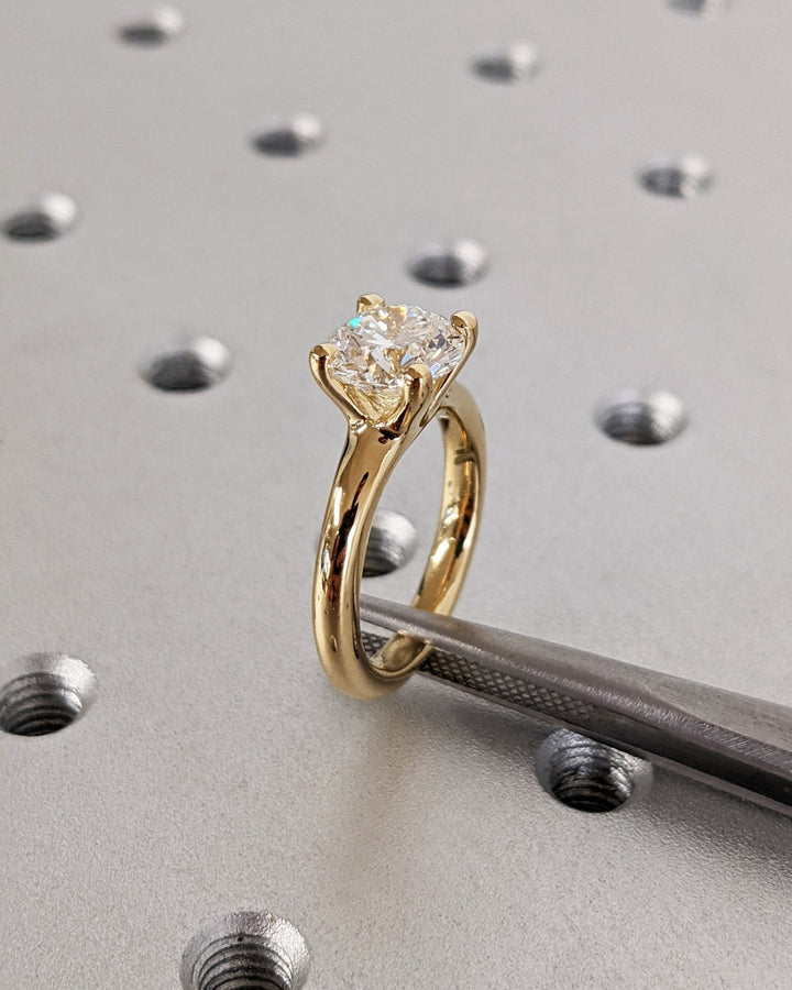 Round solitaire engagement ring viewed from the side