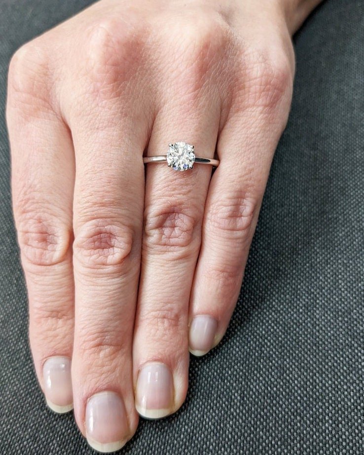 Unboxing view of round cut solitaire diamond engagement ring
