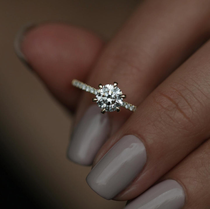 Side angle of round solitaire diamond engagement ring