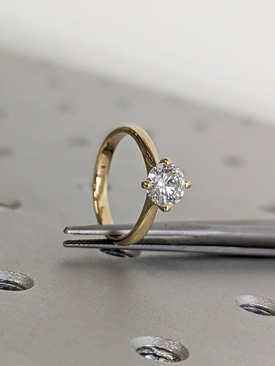 Side angle of round solitaire diamond engagement ring