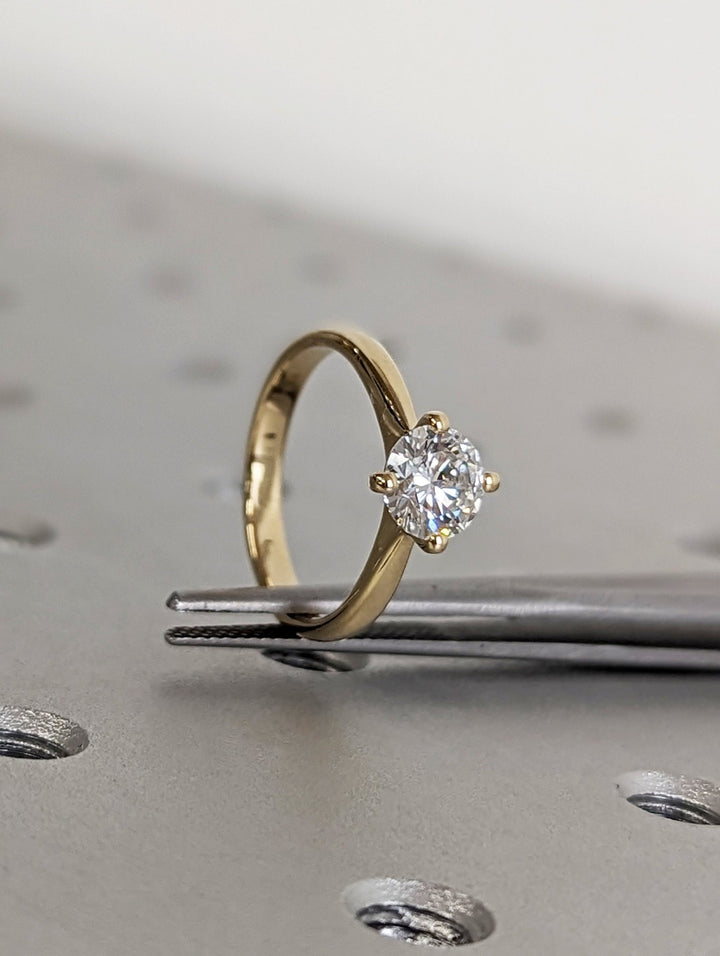 Side angle of round solitaire diamond engagement ring