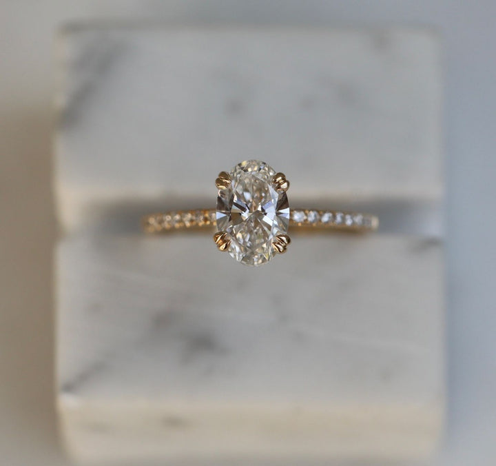 Detailed close-up of oval solitaire diamond engagement ring