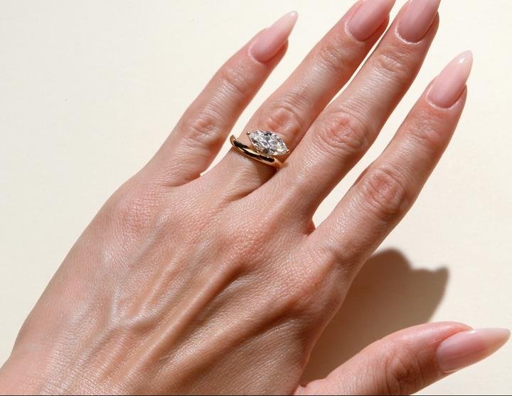 Marquise solitaire ring set with an IGI graded diamond