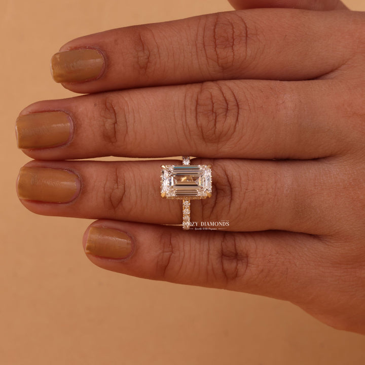 Emerald hidden halo engagement ring photographed in natural light