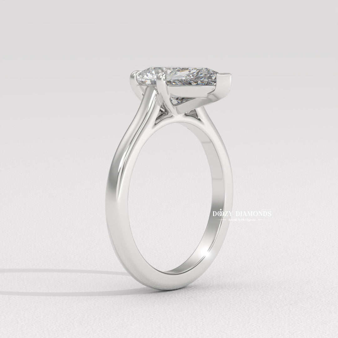 Close-up of pear cut center diamond in solitaire engagement ring