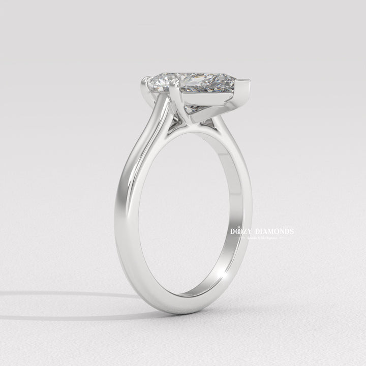 Close-up of pear cut center diamond in solitaire engagement ring