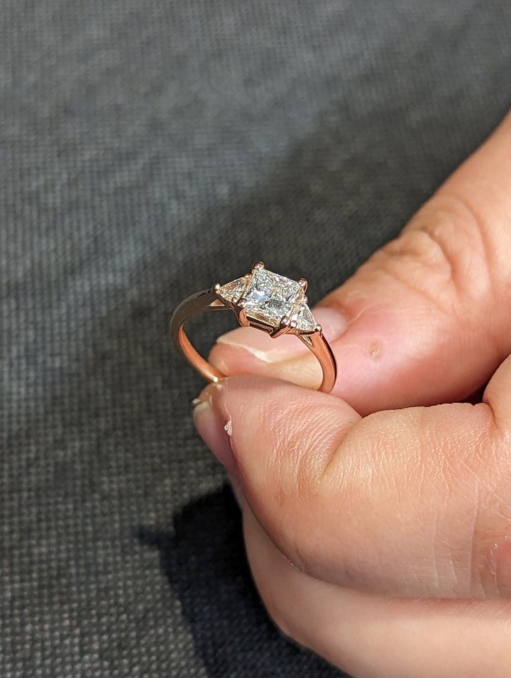 Fine craftsmanship detail on princess three stone engagement ring
