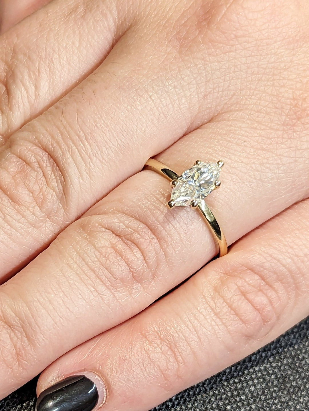 Lifestyle shot of marquise solitaire diamond ring on hand
