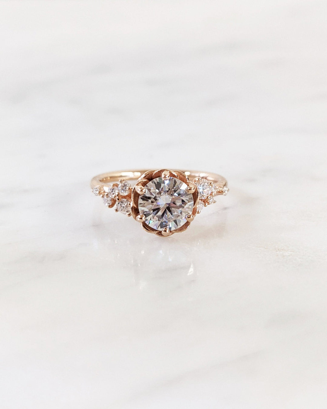 Profile view of round cut cluster engagement ring band