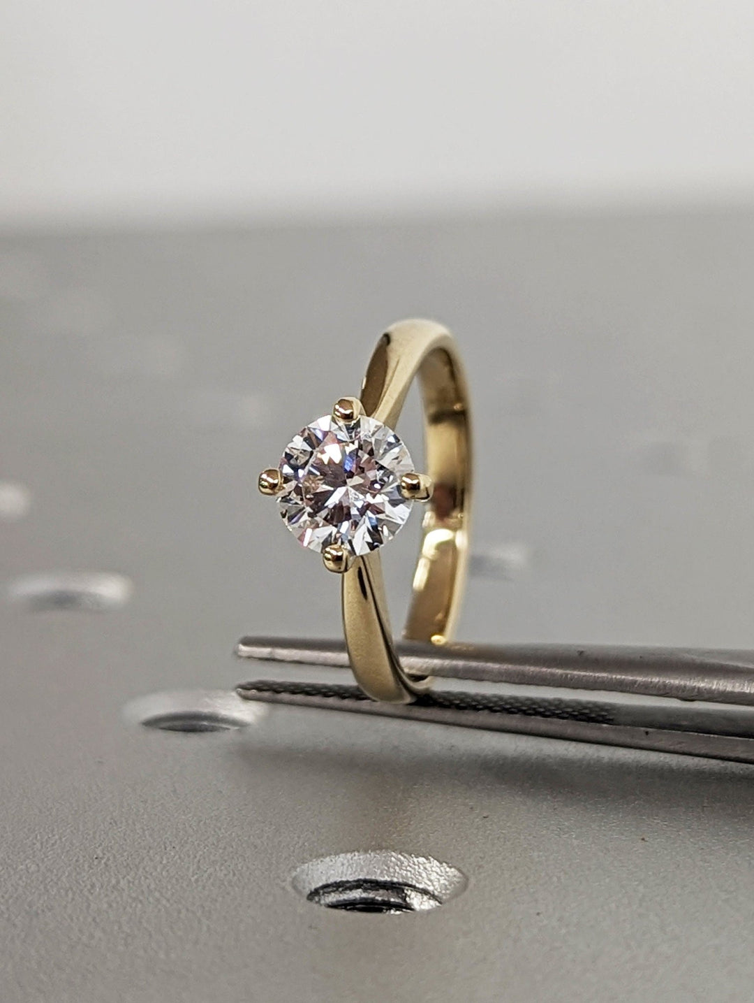 Macro shot of round cut diamond facets in solitaire ring setting
