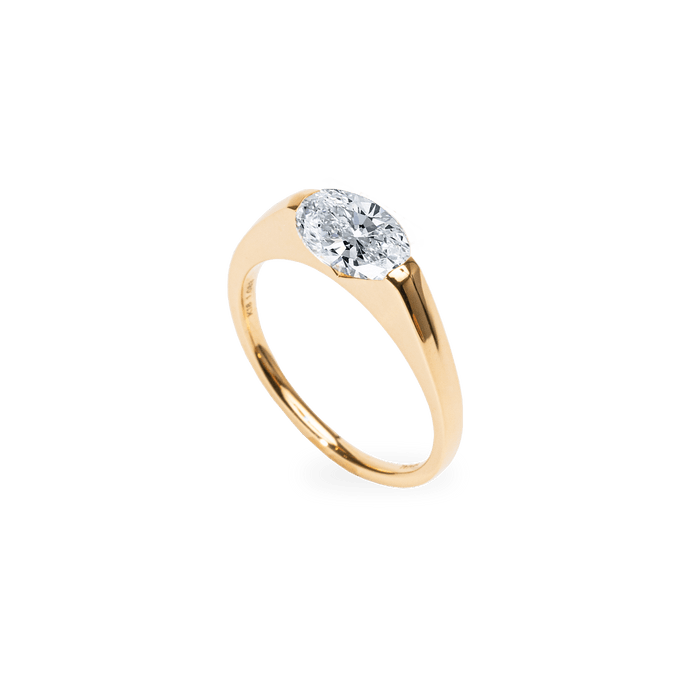 Close-up of oval cut center diamond in east west engagement ring