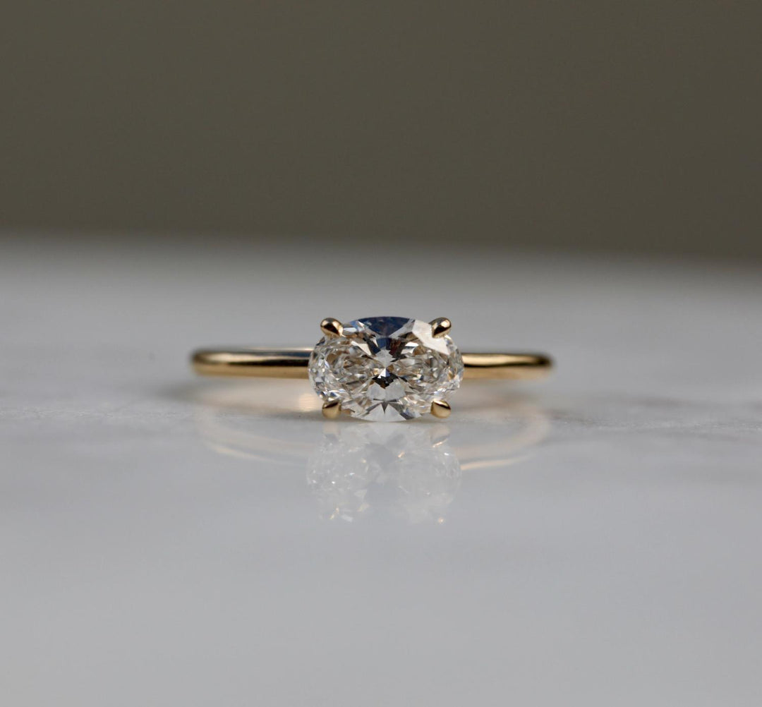 Oval solitaire engagement ring close-up showing F/VS2 diamond clarity