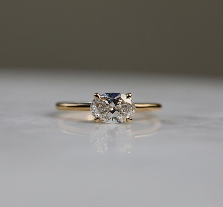Oval solitaire engagement ring close-up showing F/VS2 diamond clarity