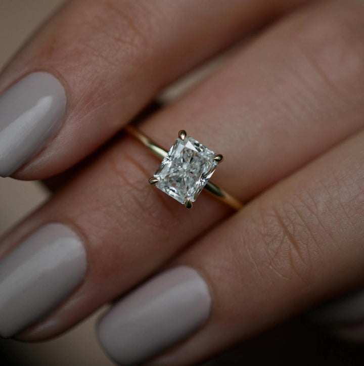 Radiant solitaire diamond ring displayed on jewelry stand