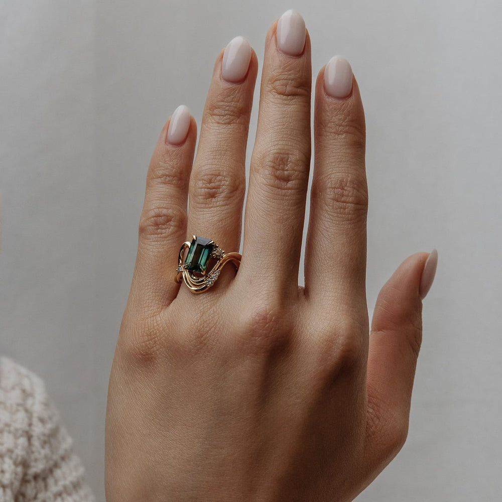 Emerald solitaire diamond ring presented in signature gift packaging