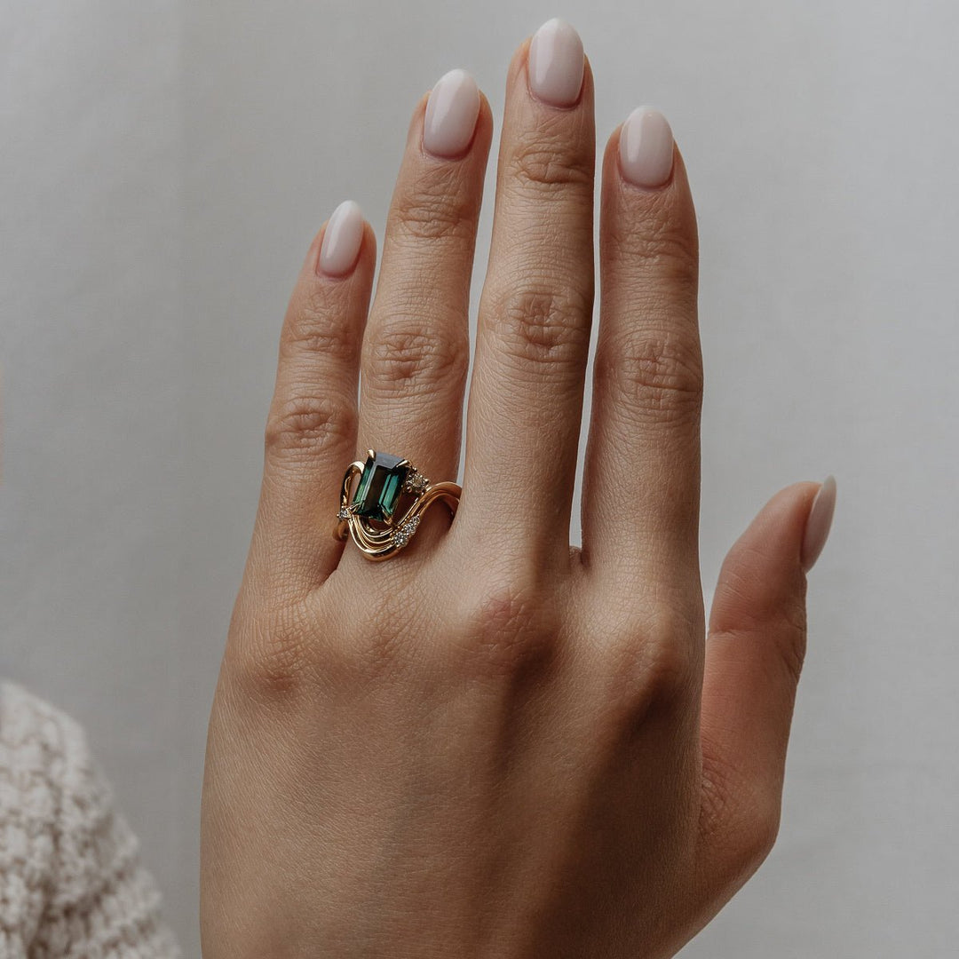Emerald solitaire diamond ring presented in signature gift packaging
