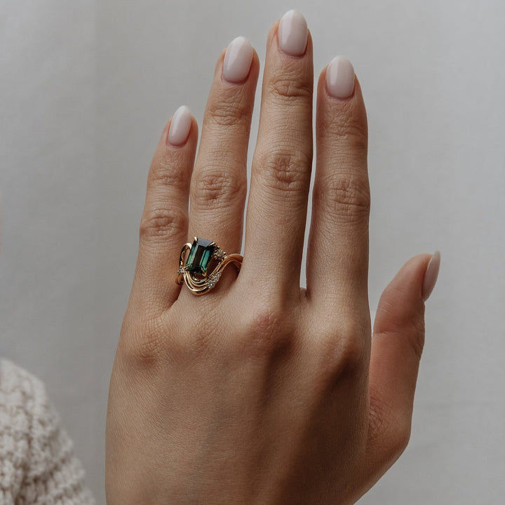 Emerald solitaire diamond ring presented in signature gift packaging