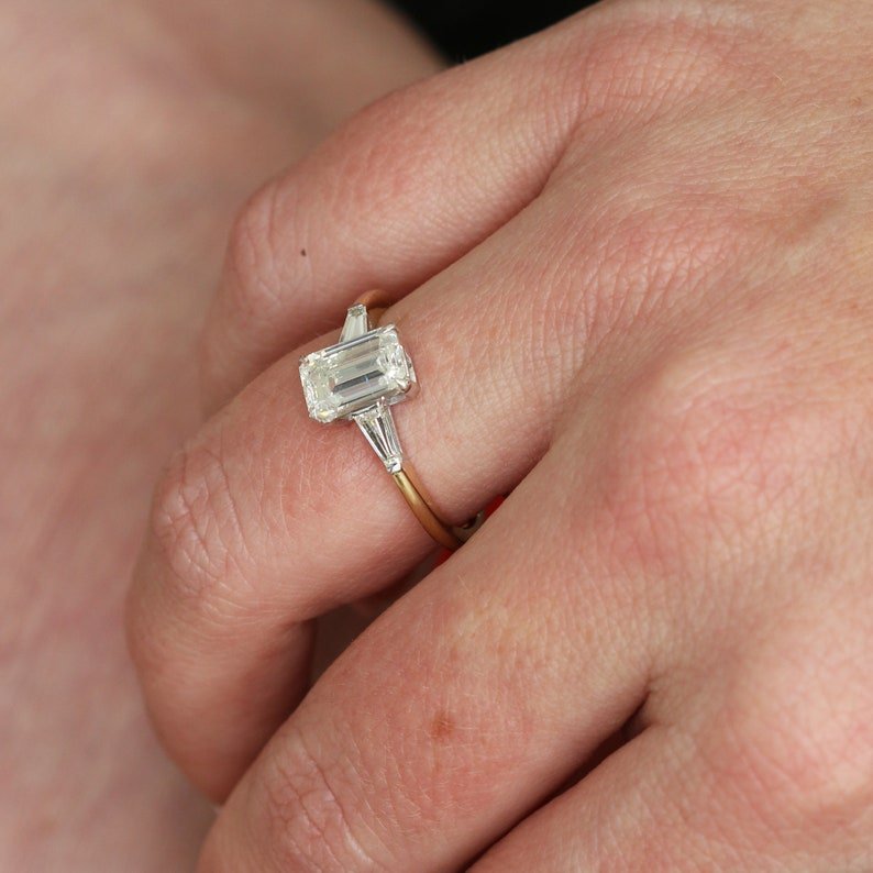 Emerald three stone engagement ring with certified lab grown diamond