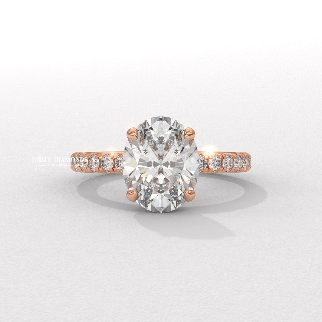 Oval hidden halo engagement ring shown on hand for true-to-life sizing