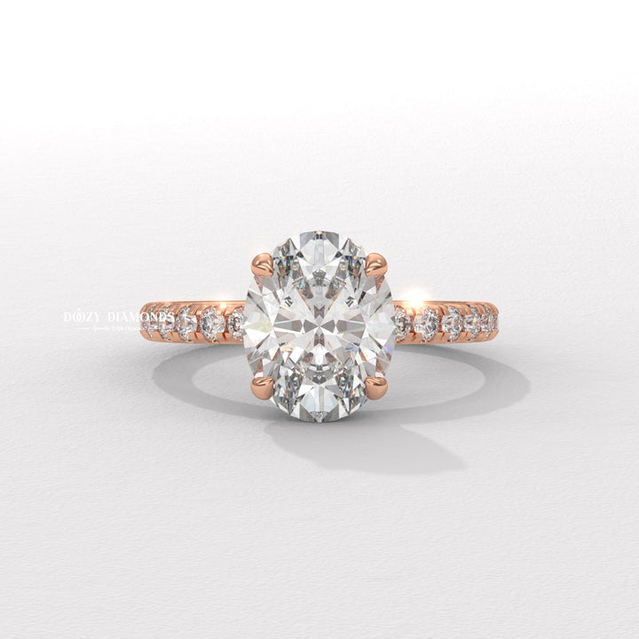 Oval hidden halo engagement ring shown on hand for true-to-life sizing